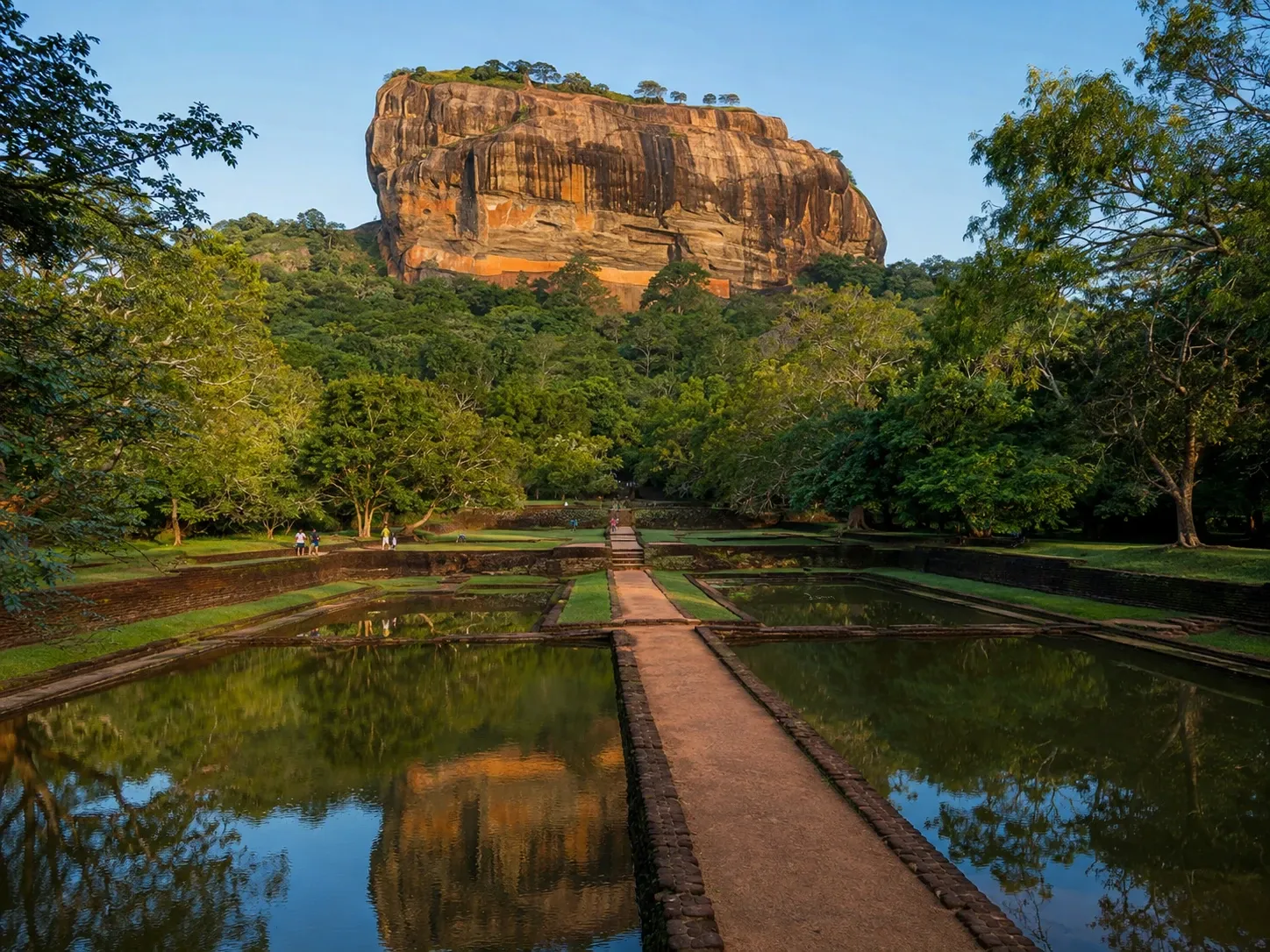 Sigiriya Lion Rock fortress rising above the ancient water gardens at sunrise, Cultural Triangle, Sri Lanka